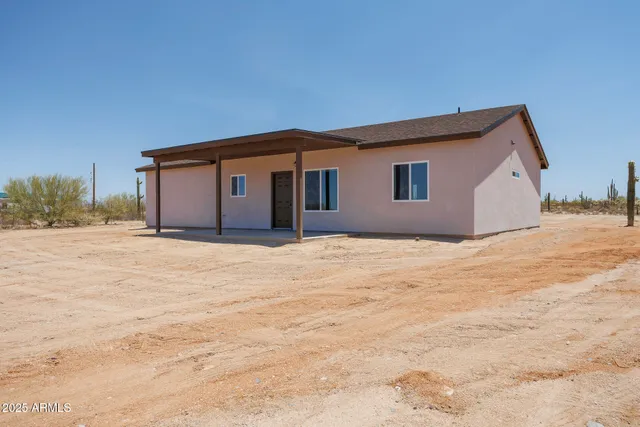 a house view with wooden fence and a bench