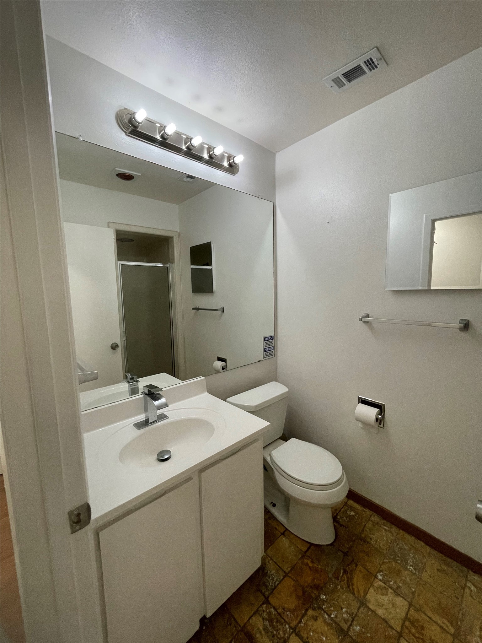 5802 Longhorn Landing Austin, TX 78734 - Photo 30 of 38 Bathroom featuring vanity, a stall shower, and stone finish flooring
