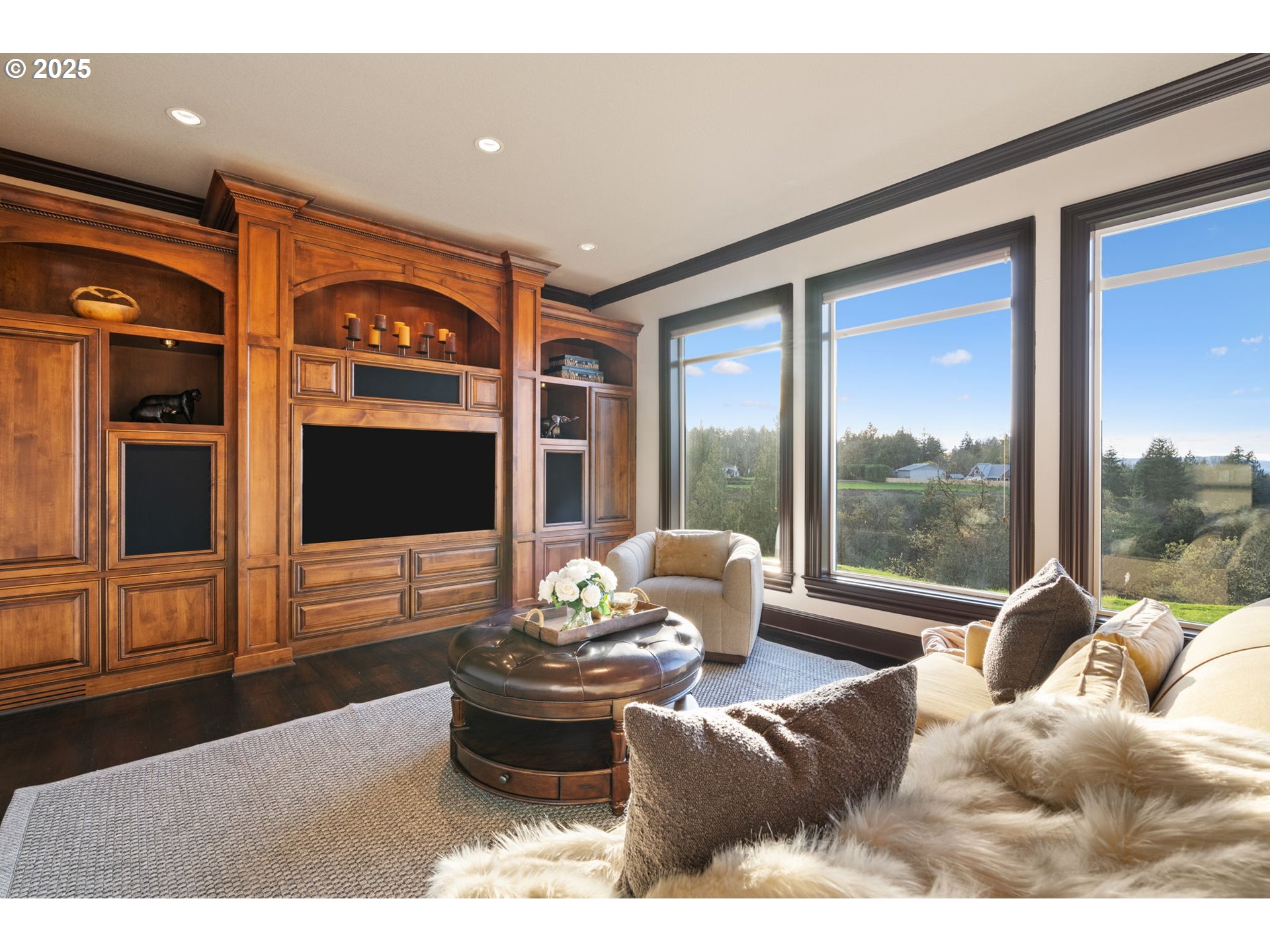 33302 Northwest 47th Court Ridgefield, WA 98642 - Photo 11 of 48 a living room with furniture tv and a floor to ceiling window