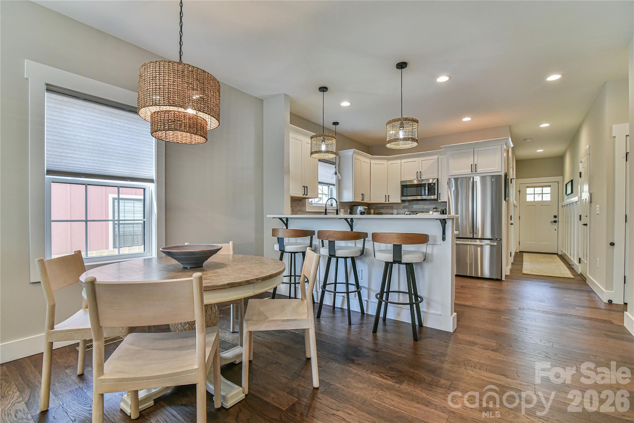 310 Portmanvilla Road Black Mountain, NC 28711 - Photo 11 of 30 a kitchen with stainless steel appliances kitchen island granite countertop a dining table chairs and white cabinets