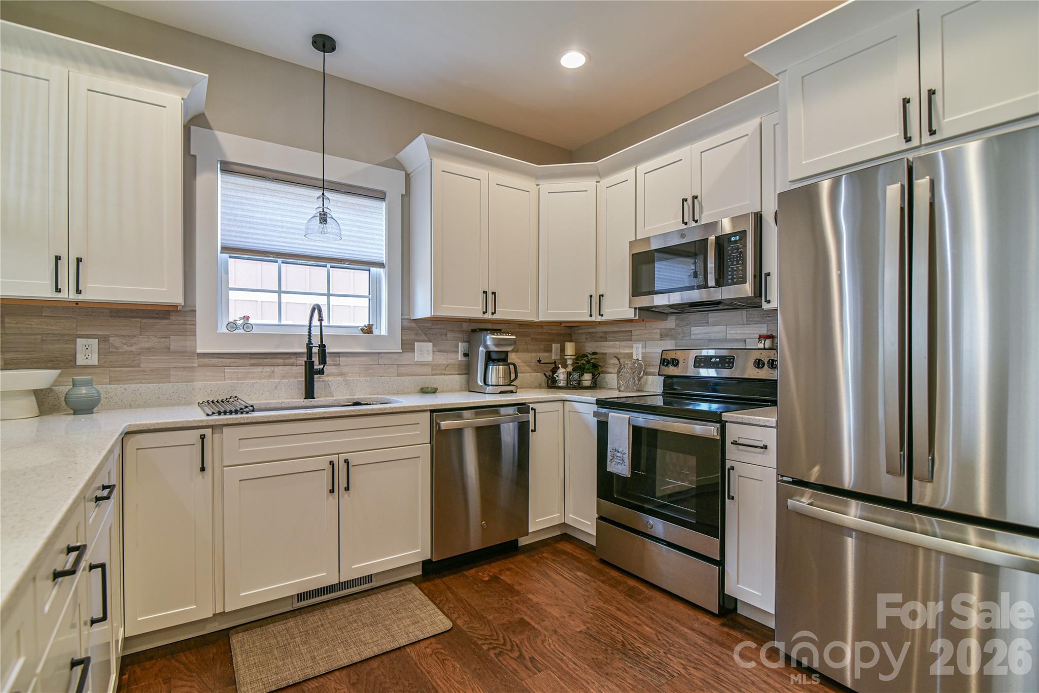 310 Portmanvilla Road Black Mountain, NC 28711 - Photo 9 of 30 a kitchen with stainless steel appliances a refrigerator sink and microwave