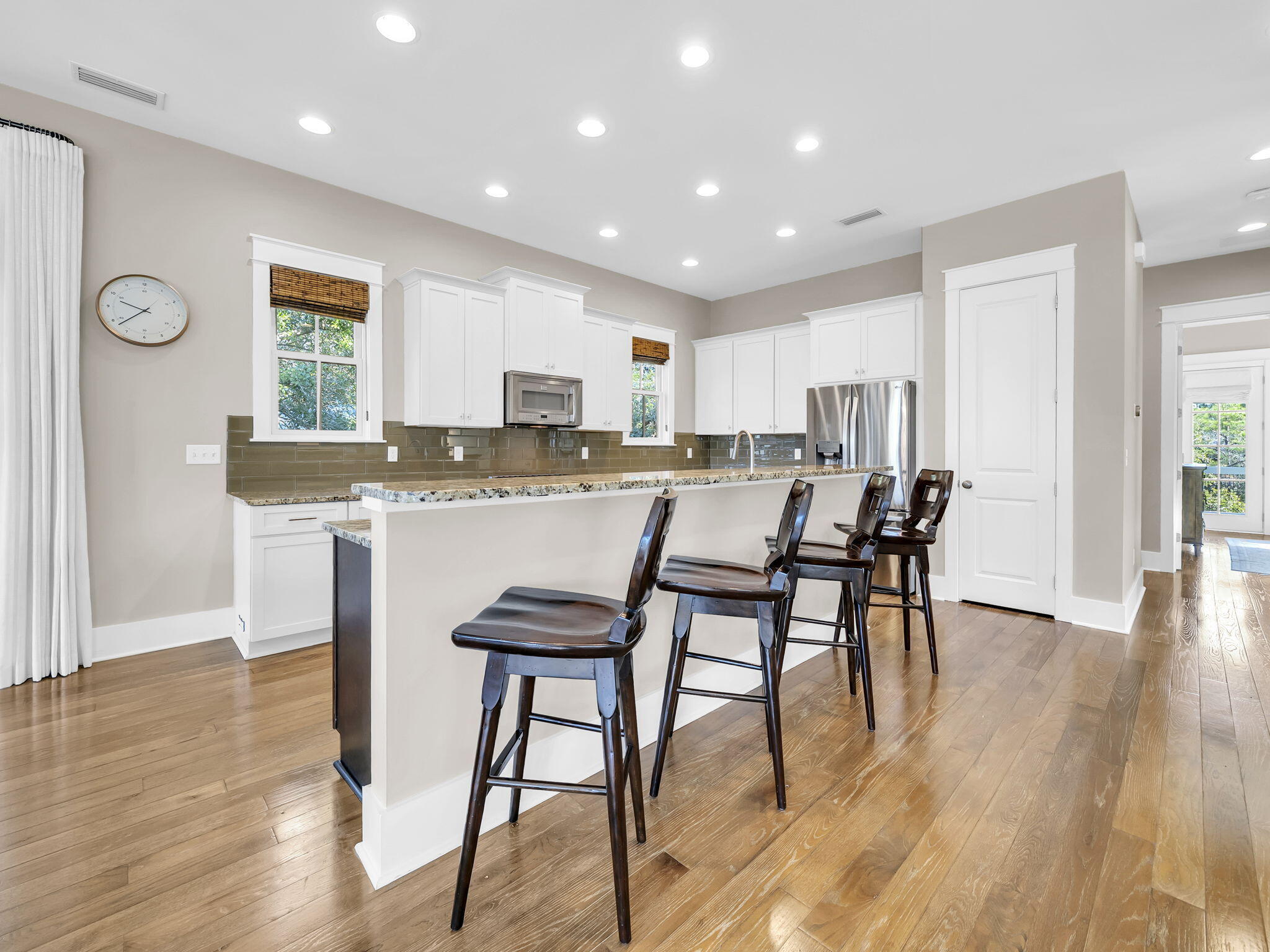 83 Cypress Walk Santa Rosa Beach, FL 32459 - Photo 32 of 77 a kitchen with kitchen island granite countertop wooden floors and white cabinets