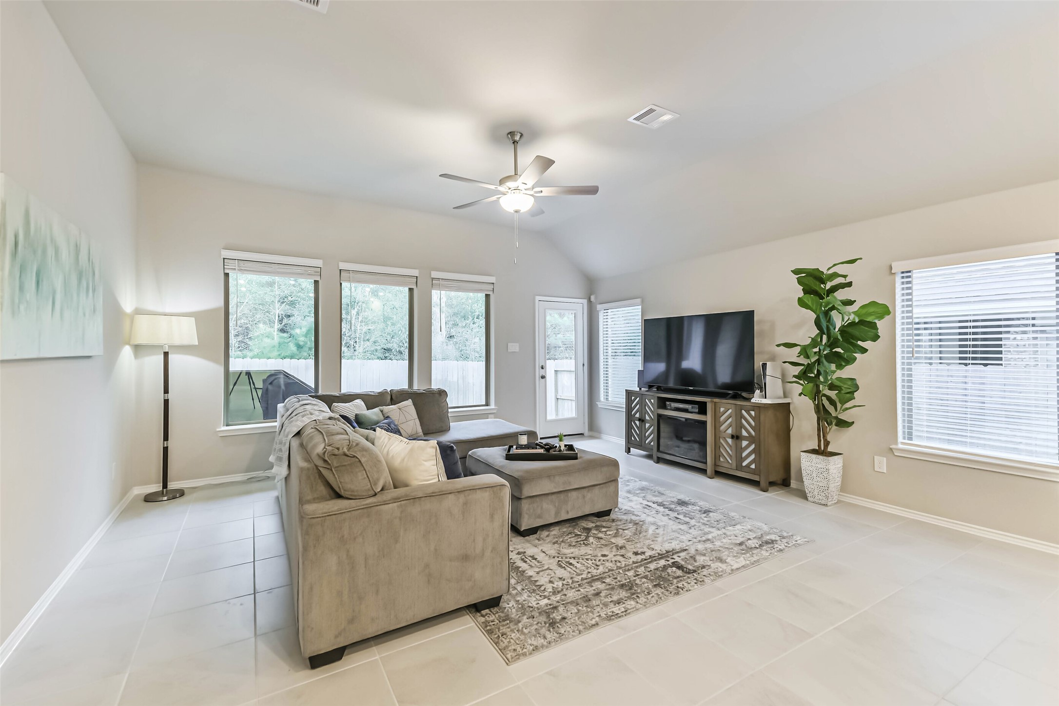 1337 Lakeside Crk Road Magnolia, TX 77354 - Photo 14 of 34 a living room with furniture a flat screen tv and a large window