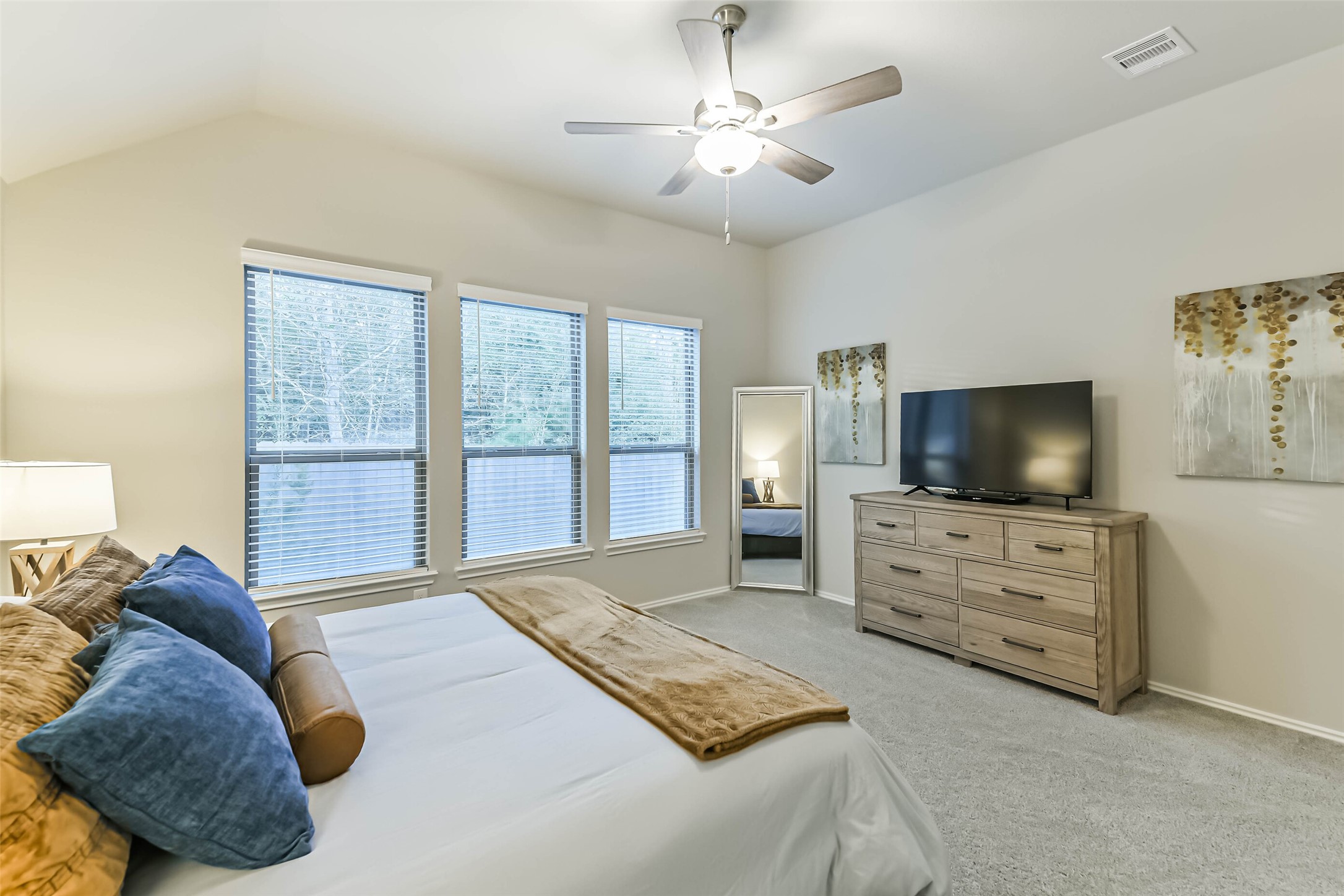 1337 Lakeside Crk Road Magnolia, TX 77354 - Photo 17 of 34 a spacious bedroom with a bed and a flat screen tv