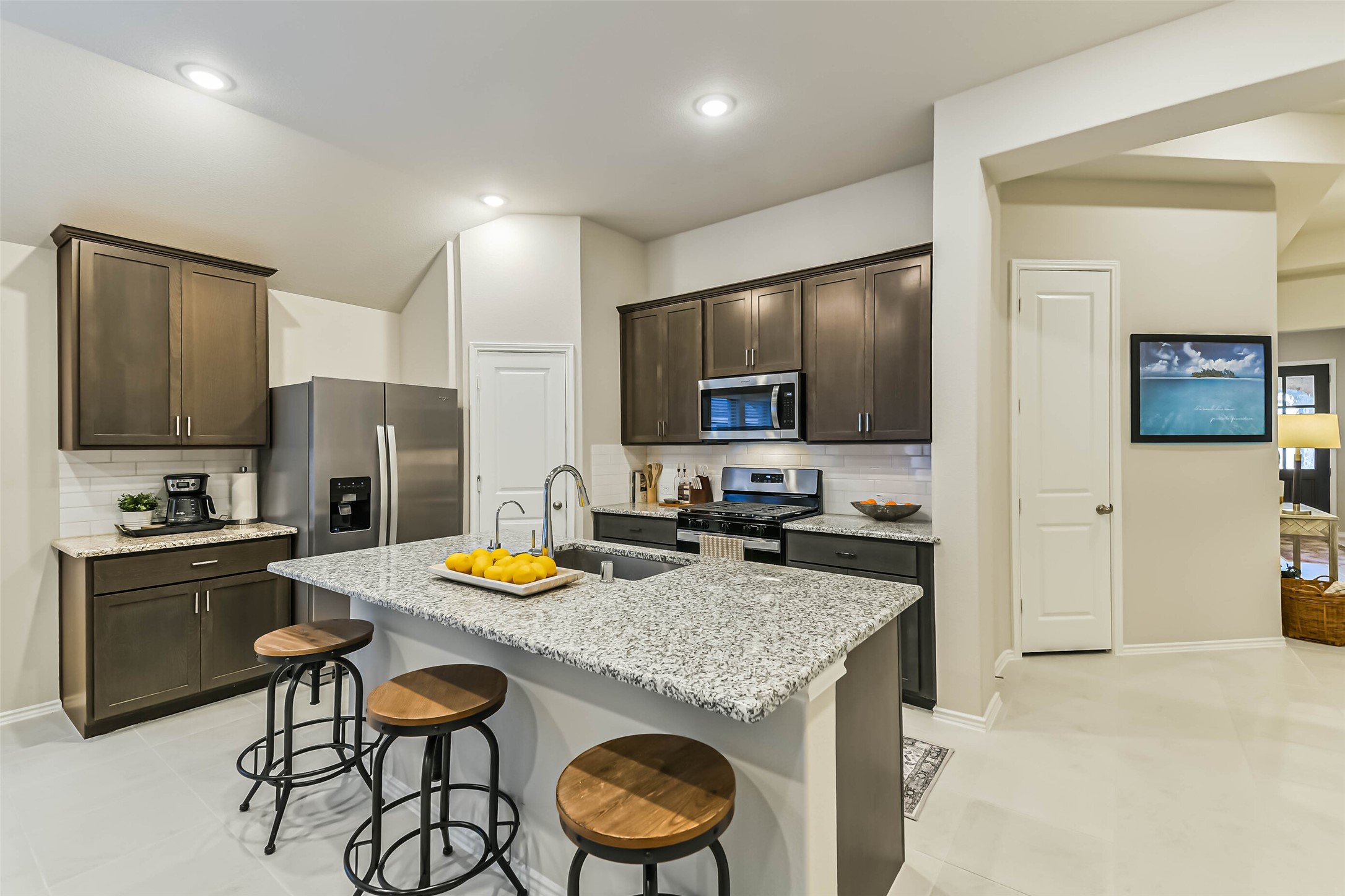 1337 Lakeside Crk Road Magnolia, TX 77354 - Photo 5 of 34 a kitchen with granite countertop stainless steel appliances a sink stove and refrigerator