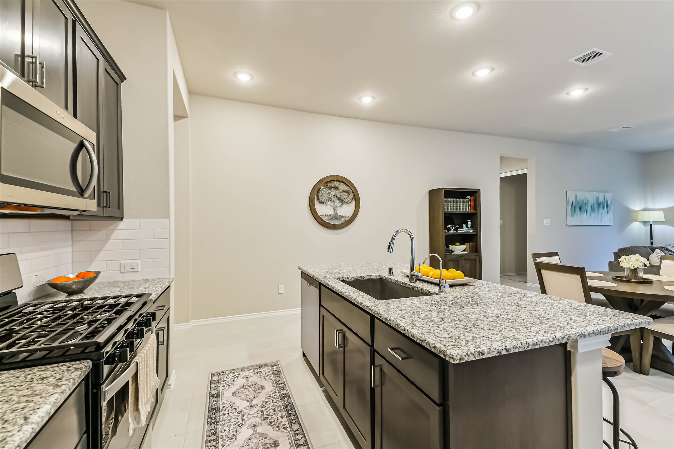 1337 Lakeside Crk Road Magnolia, TX 77354 - Photo 9 of 34 a kitchen with granite countertop stainless steel appliances stove and cabinets