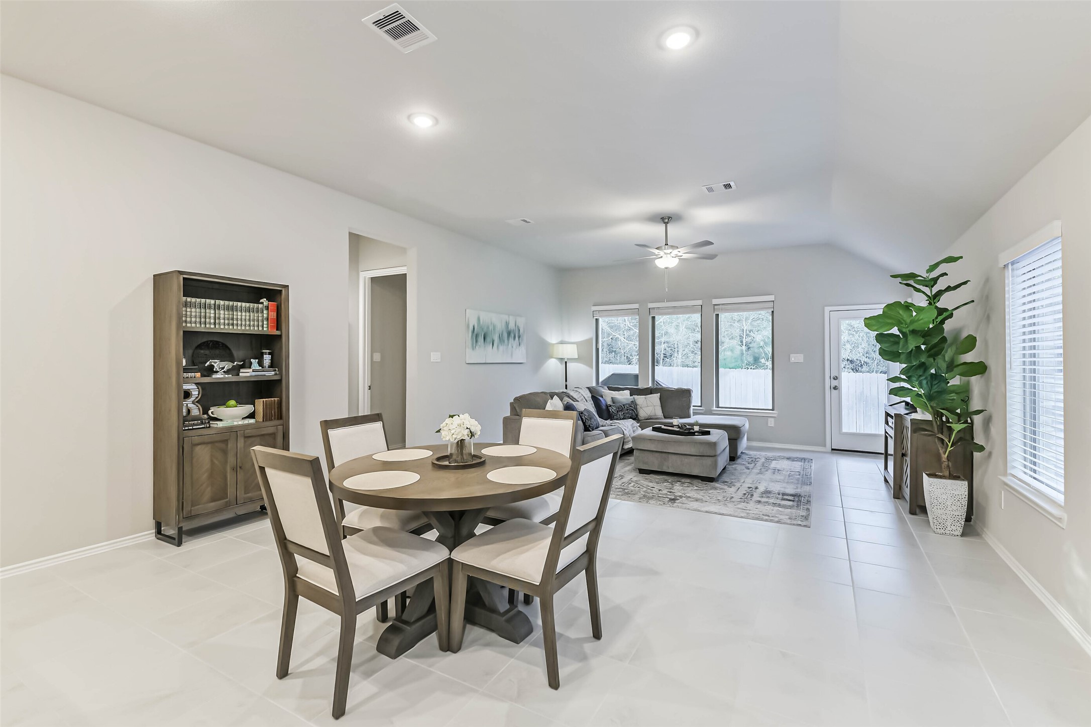 1337 Lakeside Crk Road Magnolia, TX 77354 - Photo 10 of 34 a view of a dining room with furniture and a potted plant
