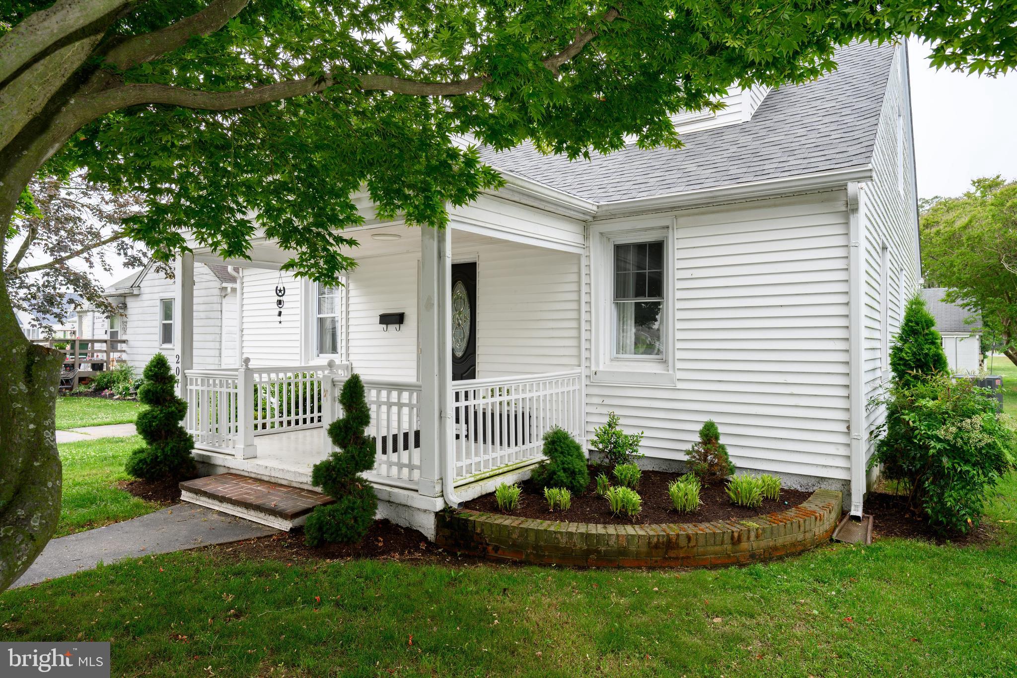 207 Crusader Road Cambridge, MD 21613 - Photo 2 of 76 a front view of a house with a garden and plants