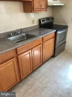 a kitchen with granite countertop a sink and cabinets