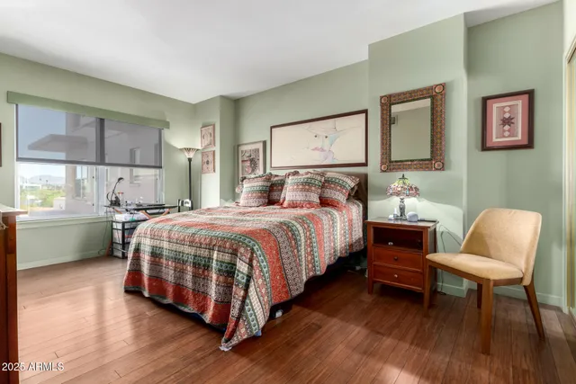 a bedroom with a bed chair and a window