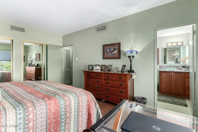 a room with a bed and a mirror