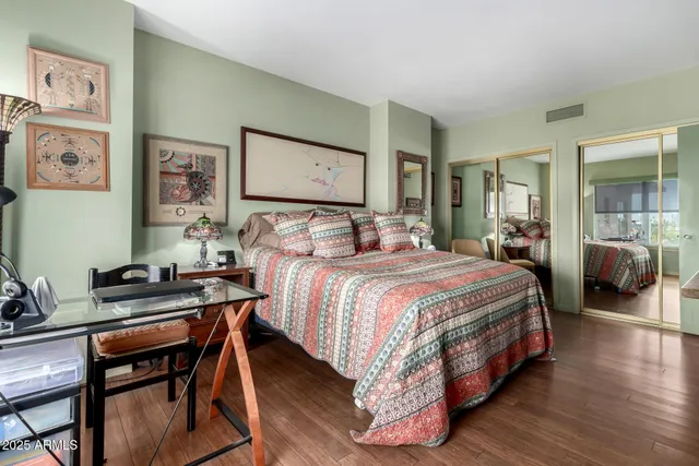 a bedroom with a bed and wooden floor