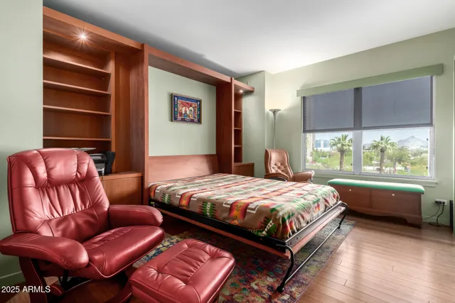 a bedroom with a bed couch and window