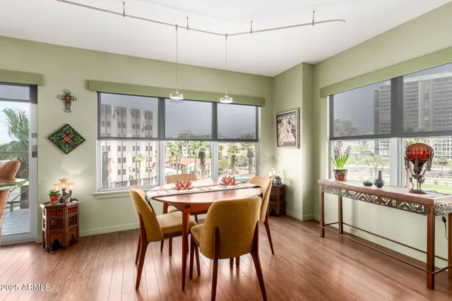 a dining room with furniture and wooden floor