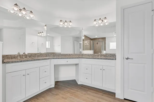 a bathroom with a granite countertop sink a large mirror and vanity