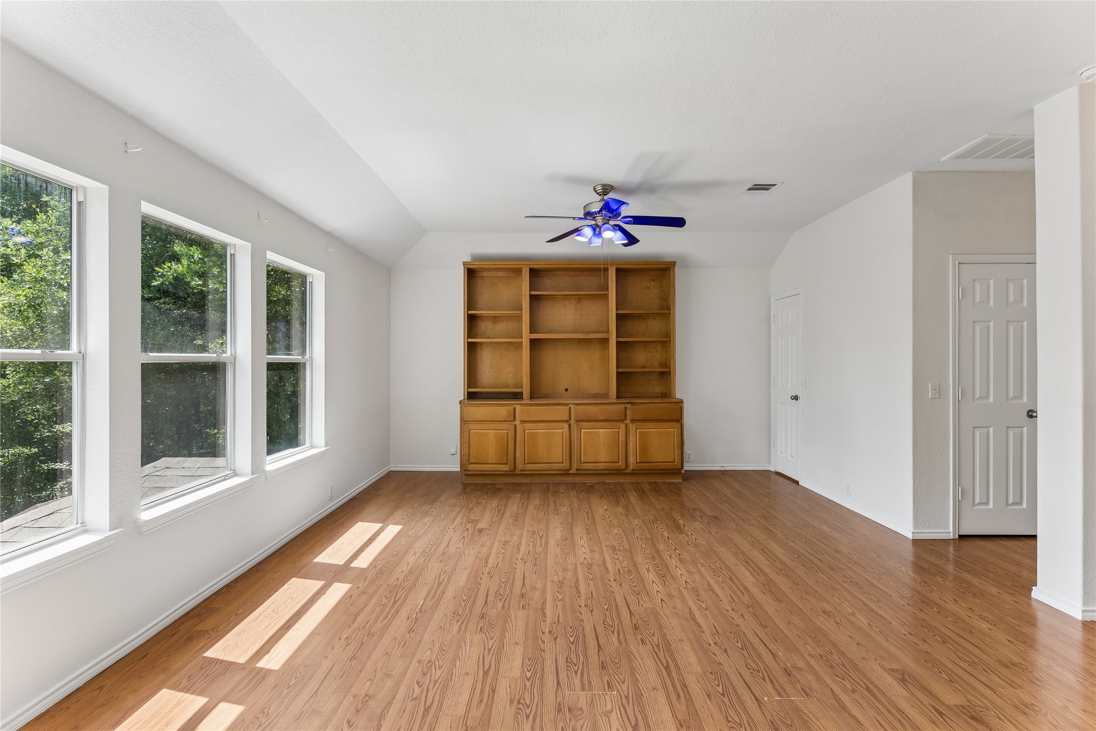 2372 Paradise Ridge Drive Round Rock, TX 78665 - Photo 26 of 40 Natural light floods this versatile living area featuring durable wood flooring and an integrated entertainment center.