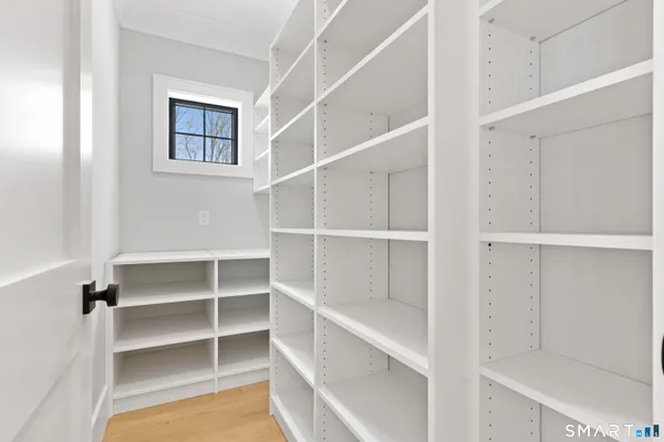 a view of walk in closet with empty racks
