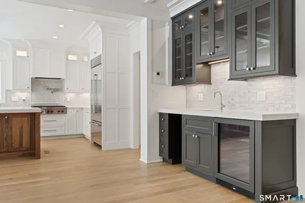 a kitchen with stainless steel appliances granite countertop a refrigerator and a sink