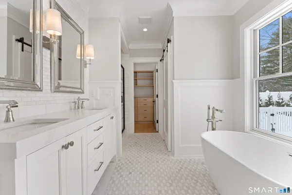 a bathroom with a granite countertop sink mirror and a bathtub