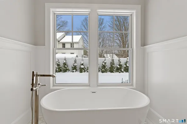 a white bath tub sitting next to a window