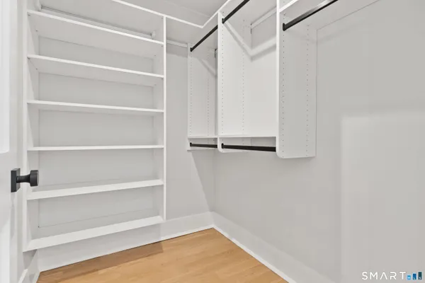 a view of walk in closet with empty racks