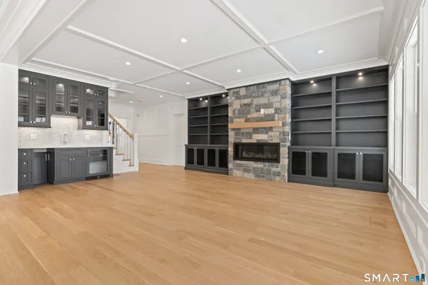 a view of an empty room with a fireplace and a window