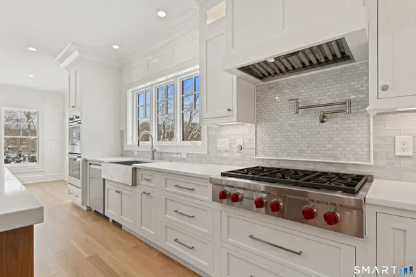 a kitchen with stainless steel appliances cabinets and a window