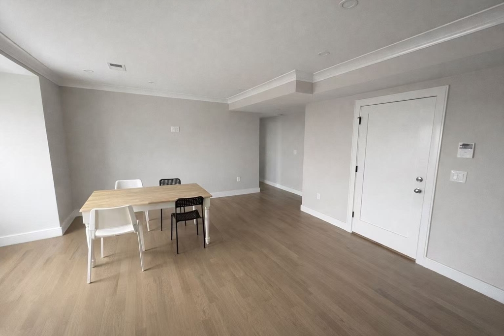 13 Greylock Road, Unit 3 Boston, MA 02134 - Photo 2 of 10 a workspace with furniture window and wooden floor