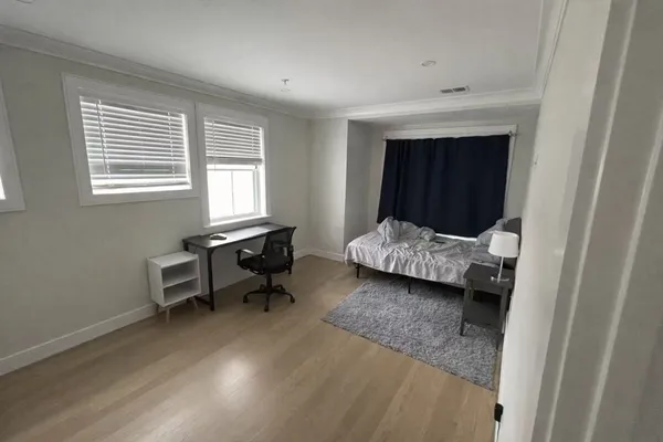 a bedroom with a bed and a window