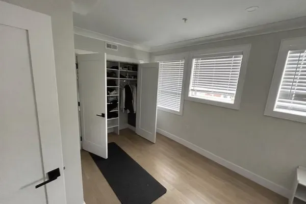 a view of walk in closet with empty racks