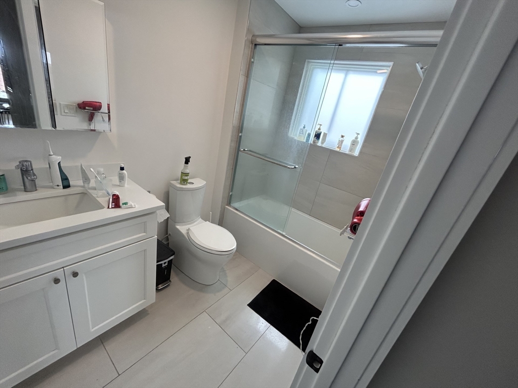 13 Greylock Road, Unit 3 Boston, MA 02134 - Photo 8 of 10 a bathroom with a sink and a mirror