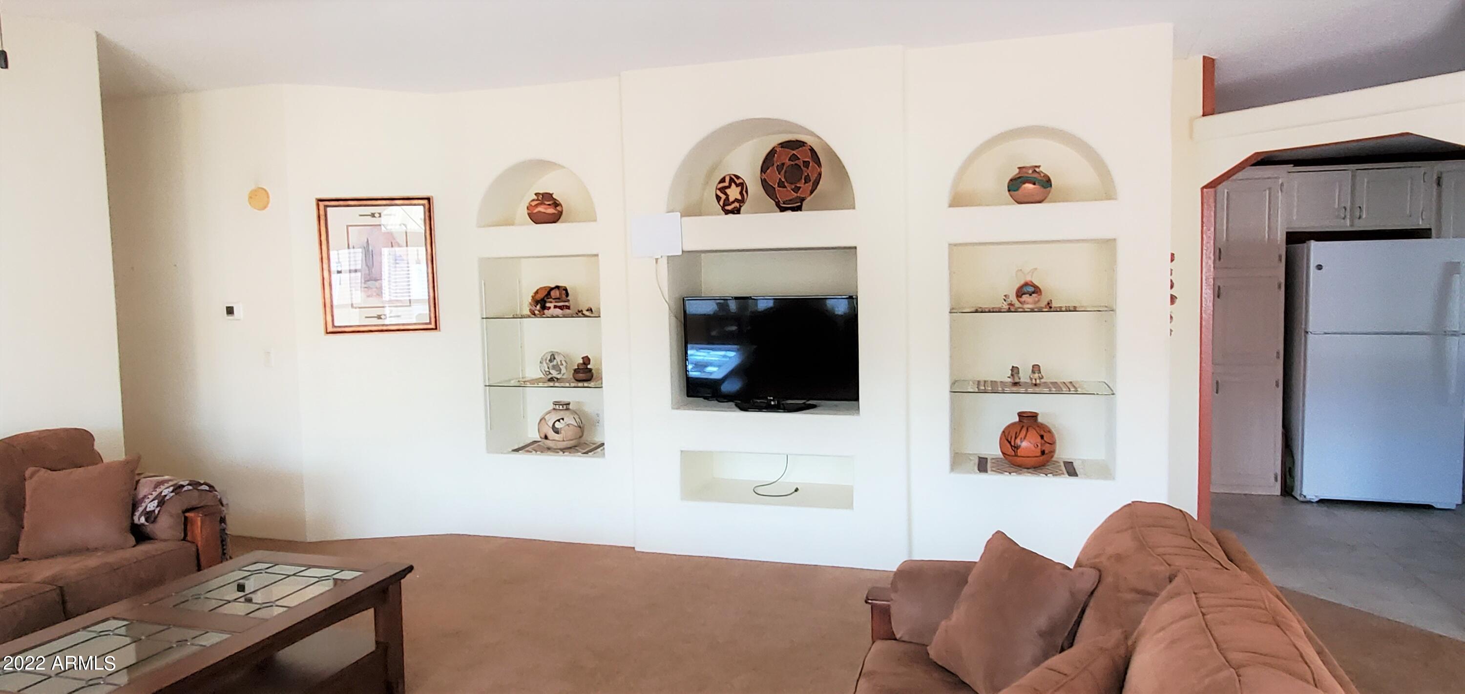 11201 North El Mirage Road, Unit A22 El Mirage, AZ 85335 - Photo 13 of 41 Living Room Shelf Area w TV