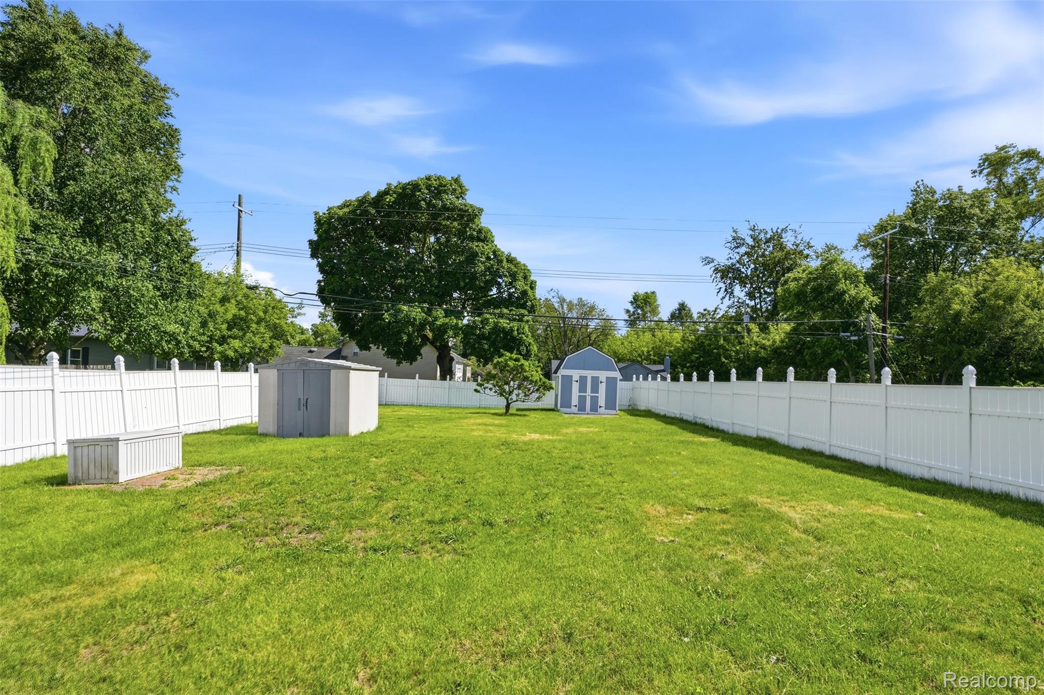3829 West Auburn Road Rochester, MI 48309 - Photo 2 of 2 Expansive lawn area enclosed by a white vinyl privacy fence
