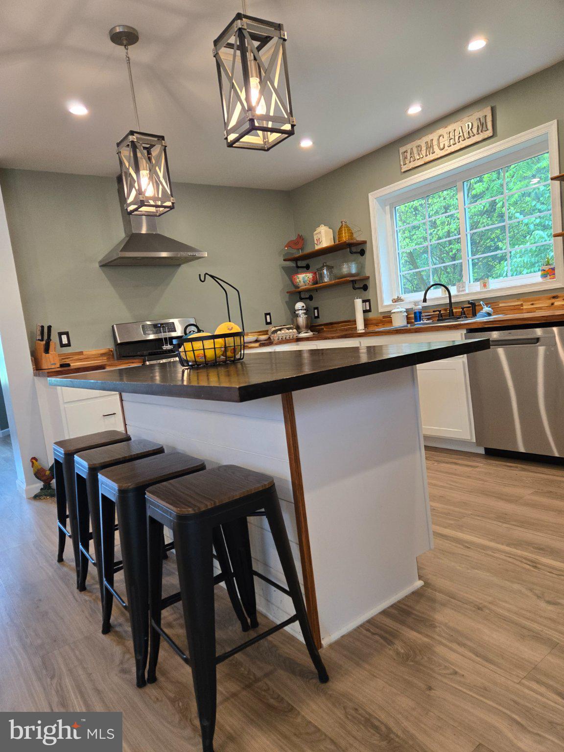 1669 Colebrook Road Lebanon, PA 17042 - Photo 22 of 34 a kitchen with stainless steel appliances granite countertop a sink a stove a dining table and chairs