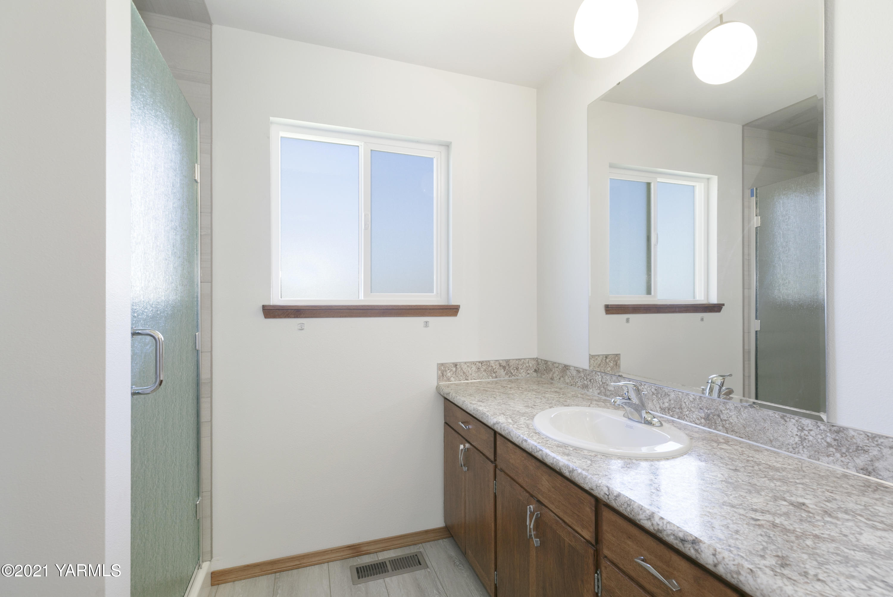 413 Wendt Road Yakima, WA 98901 - Photo 16 of 24 a bathroom with a granite countertop sink and a mirror