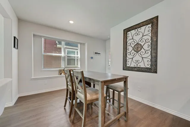 a view of a dining room with furniture and window