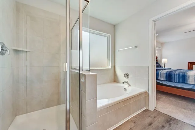a bathroom with a tub and shower