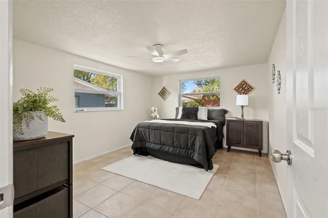 a bathroom with a granite countertop sink mirror vanity and toilet