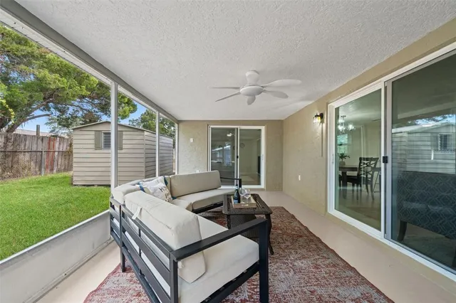 a view of a backyard with wooden fence and a large tree