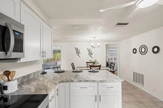a view of a dining room with furniture and a chandelier