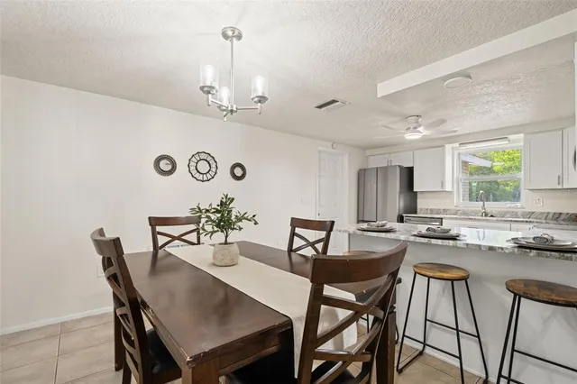 a living room with furniture a large window and a table