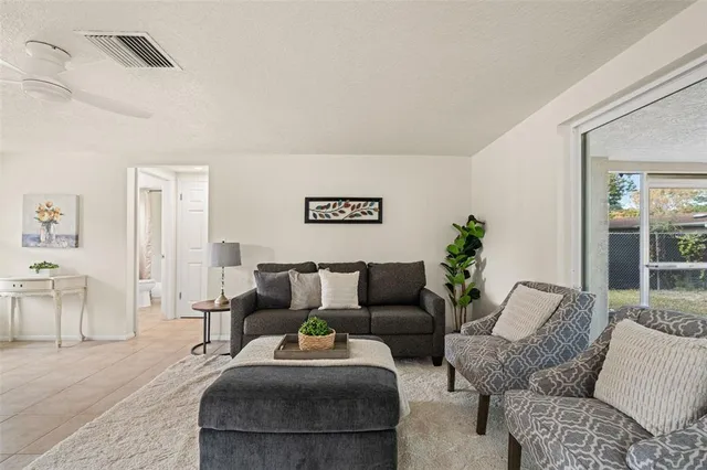 a living room with furniture and a large window