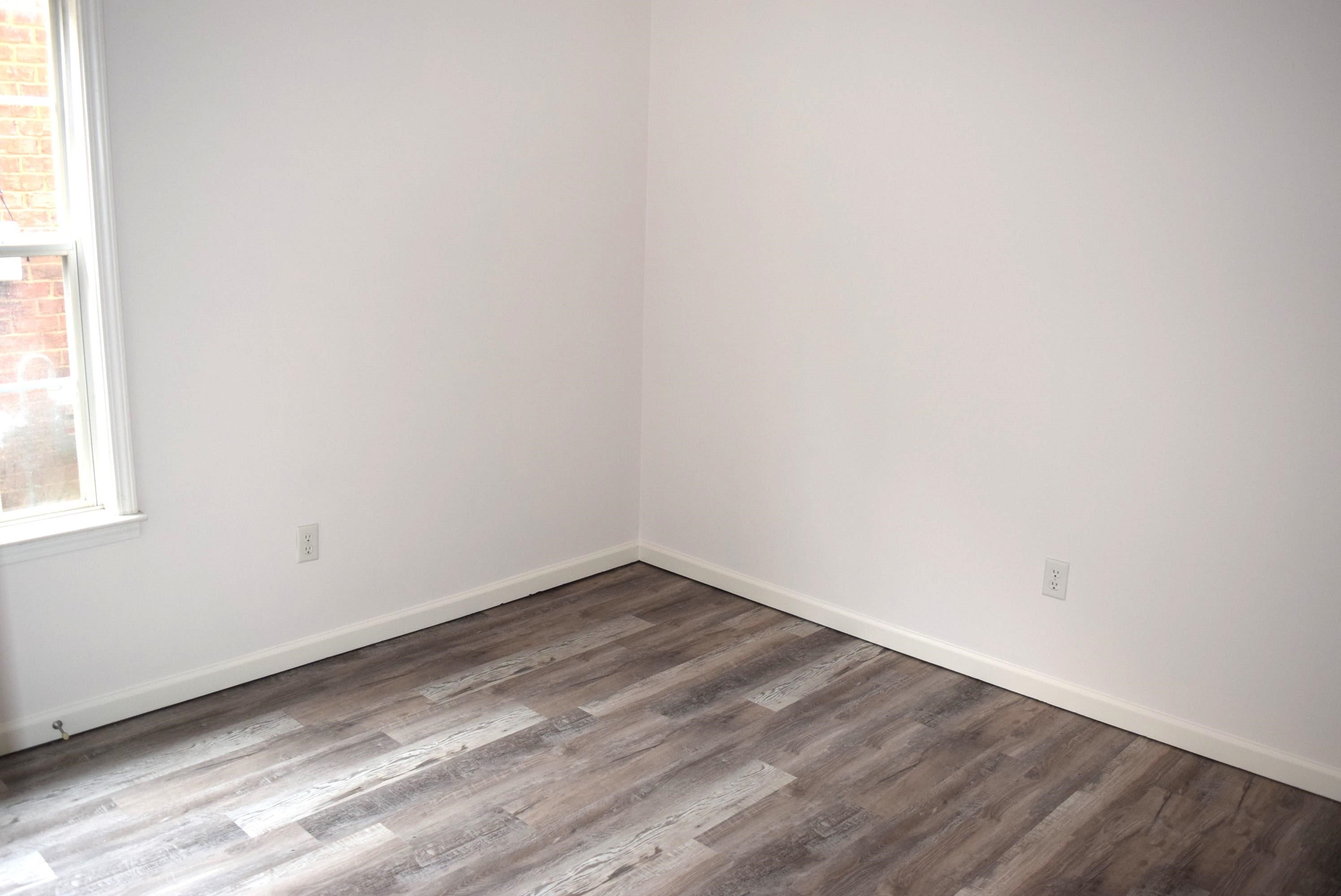 8739 Eagle View Drive Memphis, TN 38018 - Photo 13 of 18 a view of an empty room with wooden floor and a window