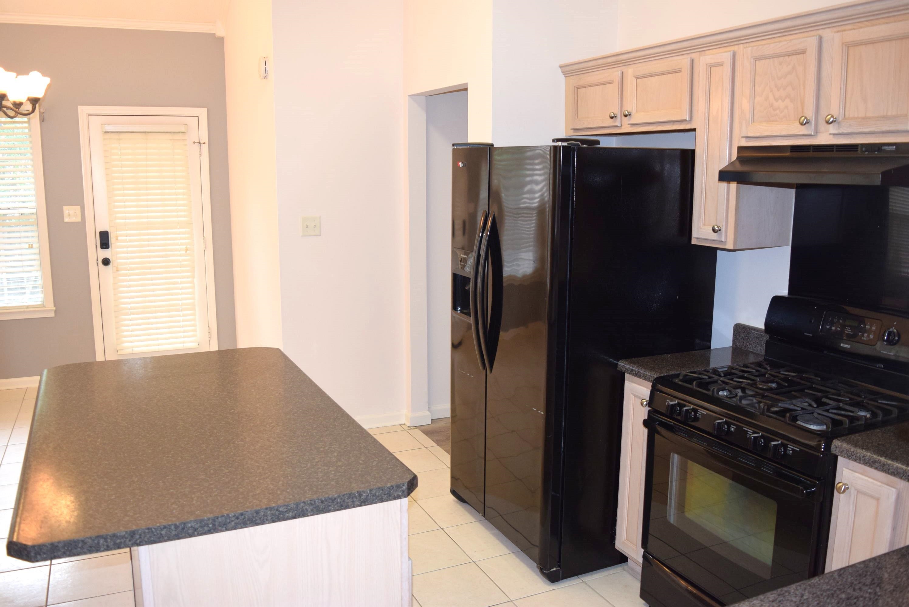 8739 Eagle View Drive Memphis, TN 38018 - Photo 3 of 18 a kitchen with stainless steel appliances granite countertop a refrigerator a stove and a sink