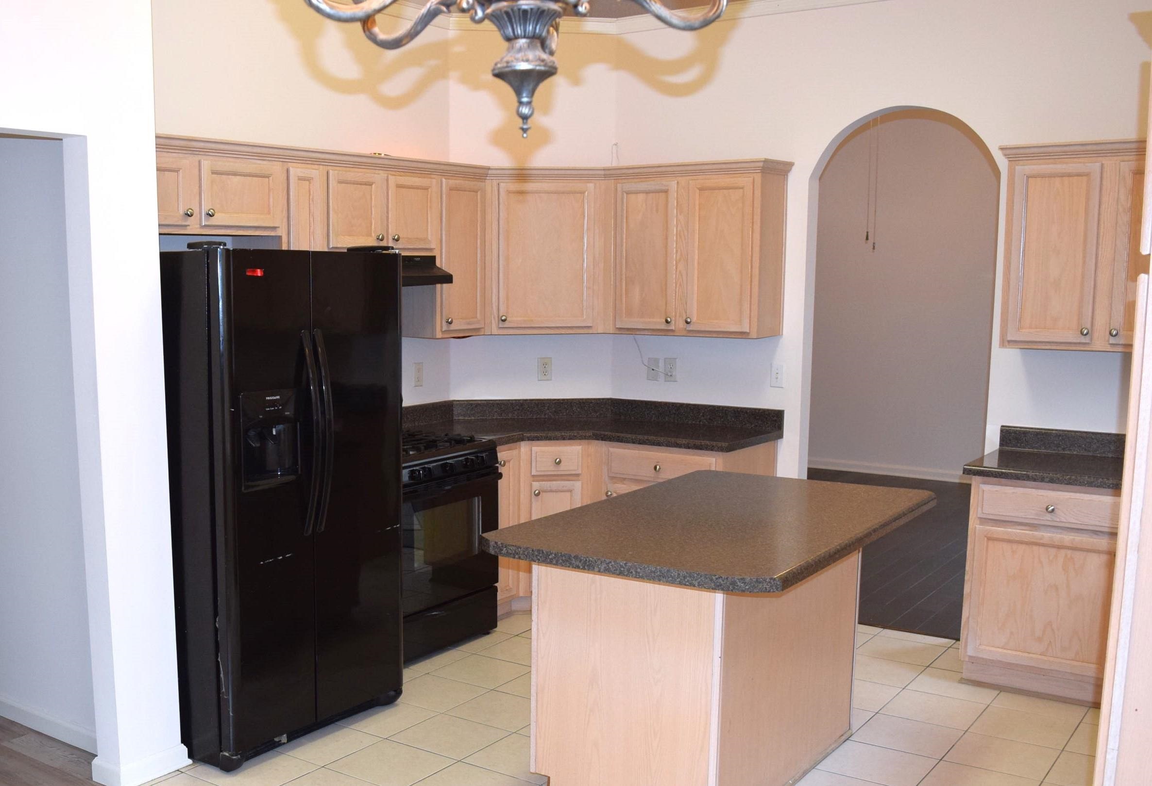 8739 Eagle View Drive Memphis, TN 38018 - Photo 4 of 18 a kitchen with granite countertop a refrigerator and a stove