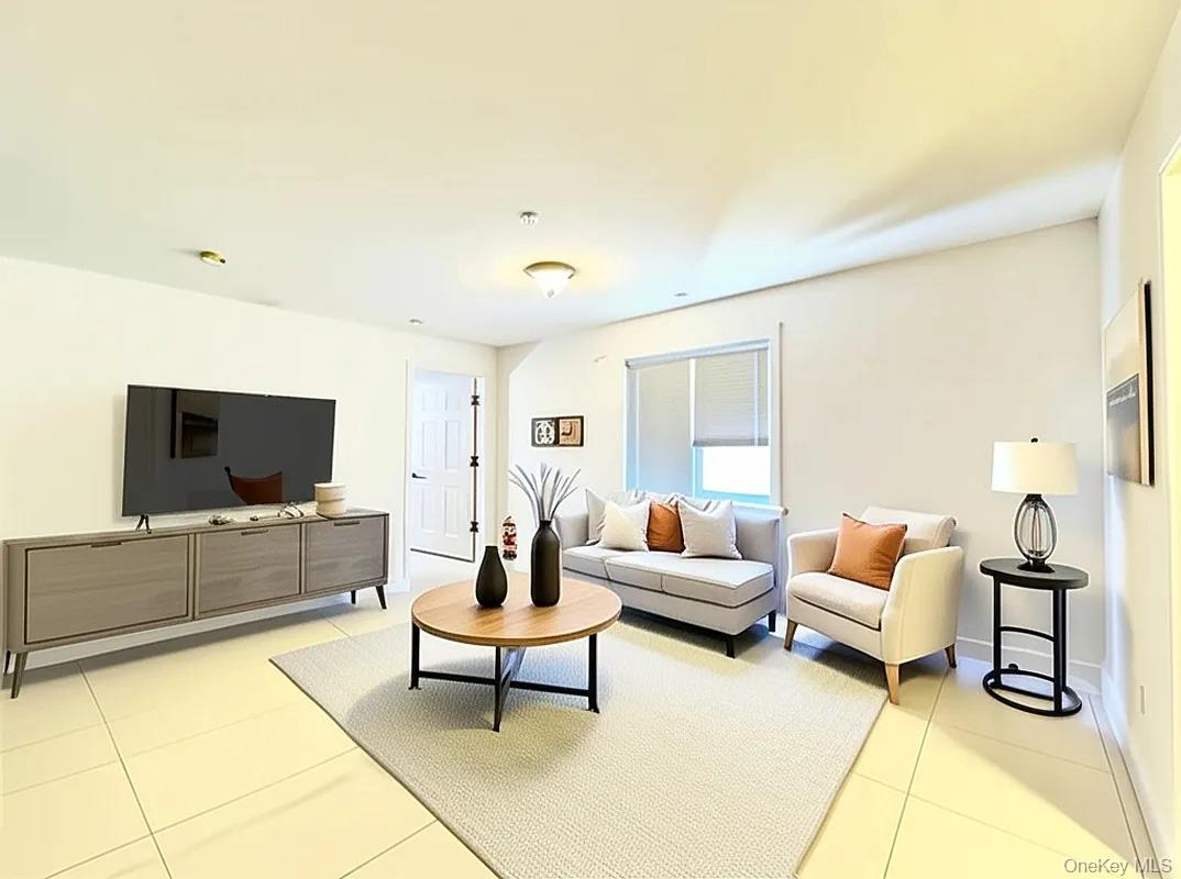 Living area with light tile patterned floors and baseboards