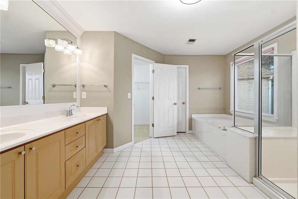 5145 Harbour Ridge Drive Alpharetta, GA 30005 - Photo 13 of 25 a spacious bathroom with a double vanity sink a mirror and a shower