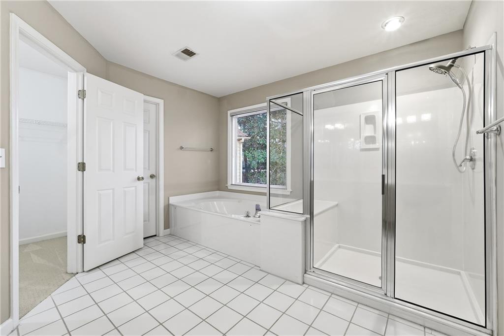 5145 Harbour Ridge Drive Alpharetta, GA 30005 - Photo 14 of 25 a spacious bathroom with a bathtub and a shower