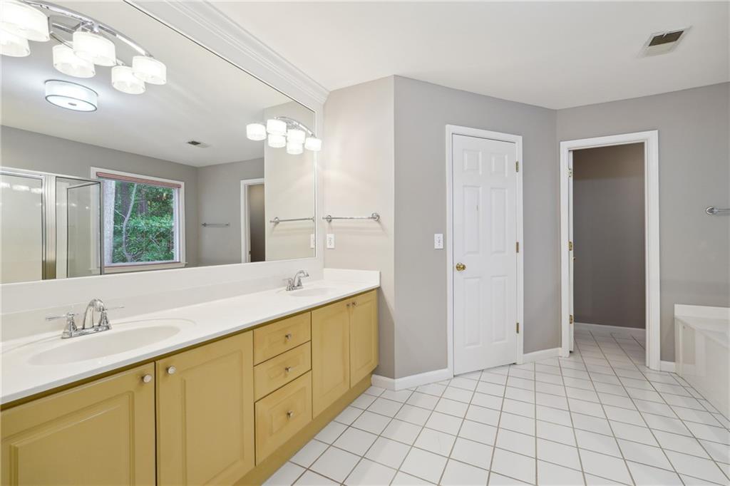 5145 Harbour Ridge Drive Alpharetta, GA 30005 - Photo 15 of 27 a spacious bathroom with a shower a sink and a mirror