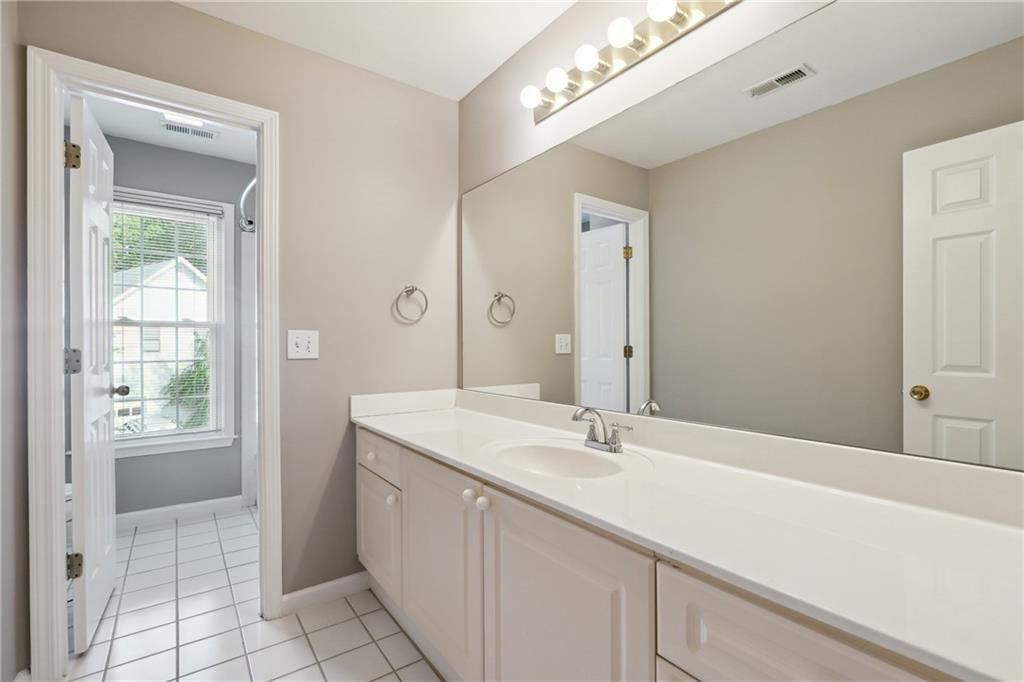 5145 Harbour Ridge Drive Alpharetta, GA 30005 - Photo 18 of 27 a bathroom with a sink vanity and a mirror